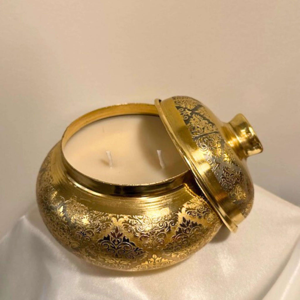 Elegant gold copper jar candle with lid, featuring a two-wick soy wax scented candle, showcasing intricate designs, scents of lily 