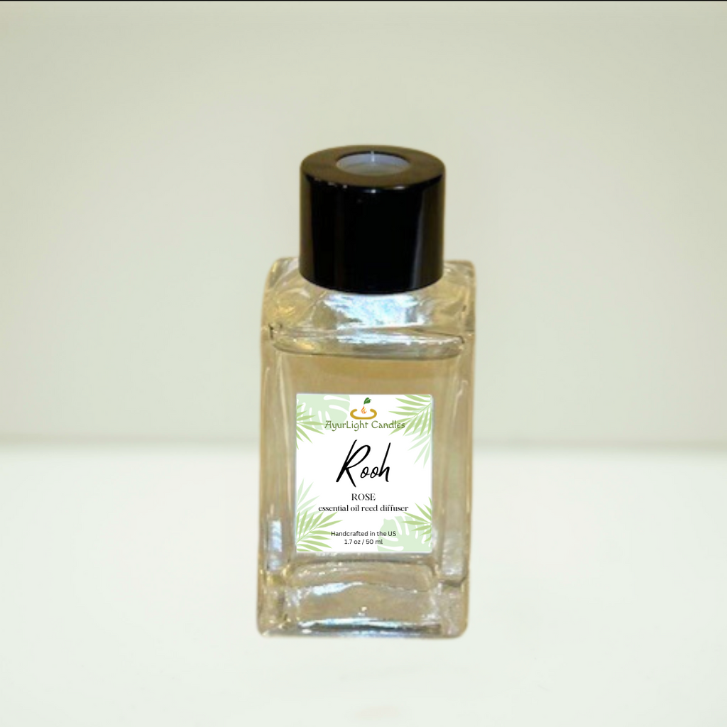 bottle of rose diffuser oil with black top